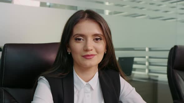 Portrait of satisfied business woman looking into camera after signing big project.