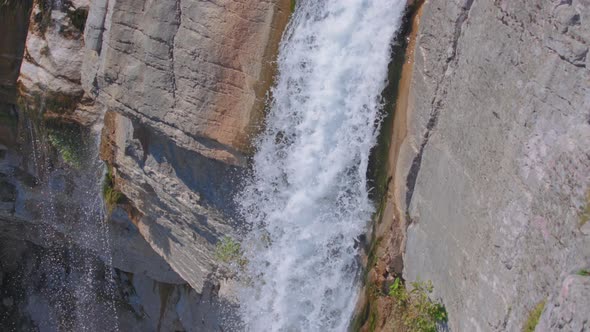 Falling water crashes into the river