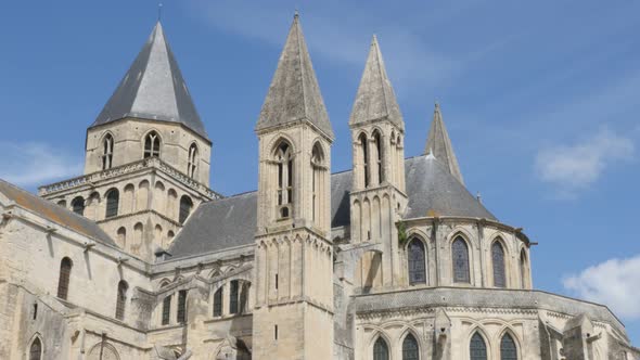 The Mens Abbey William the Conquerer church by the day in front of blue sky 4k 3840X2160 slow tilt U