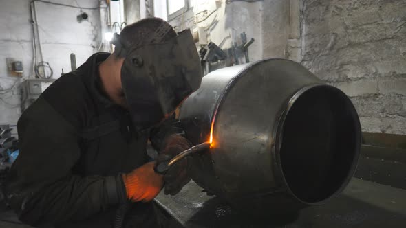 Welder Welding Metal Construction at Industrial Metalworking Production
