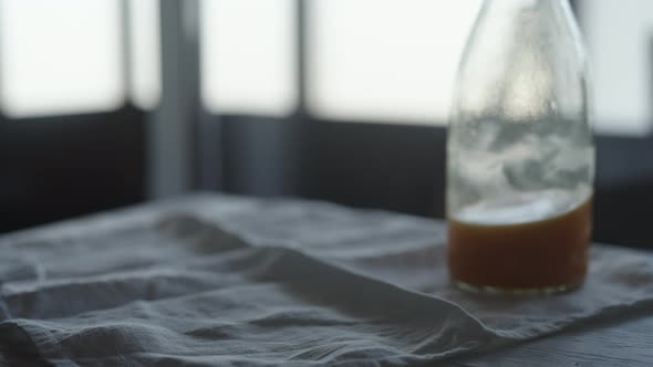 Slow Motion Man Take Orange Juice in Tumbler Glass From Linen Cloth