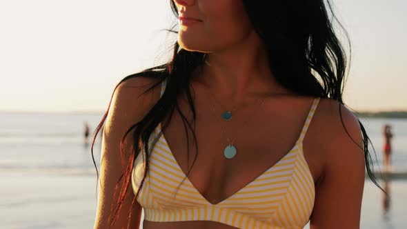 Smiling Young Woman in Bikini Swimsuit on Beach