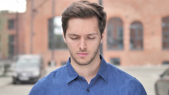 Sad Young Man Looking at Camera