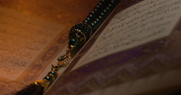 Holy Quran On Book Rest With Prayer Beads