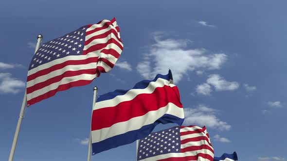 Waving Flags of Costa Rica and the USA on Sky Background