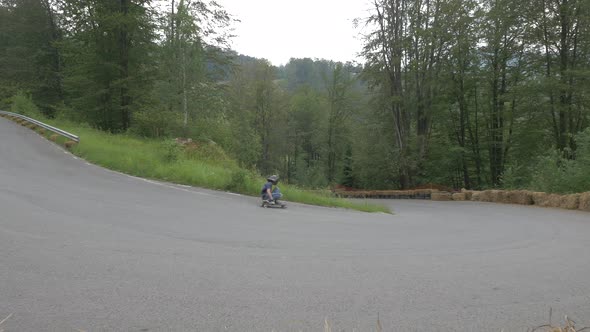 Two people longbording downhill