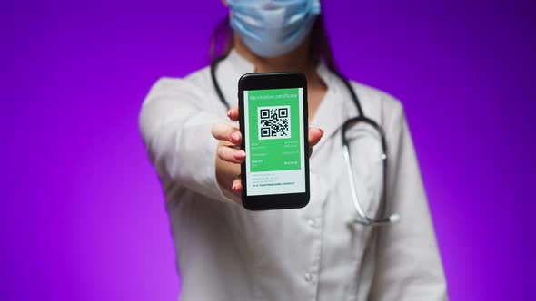 Woman Doctor in Medical Uniform Showing Vaccination Passport with Qr Code on Phone International