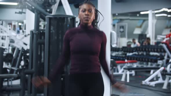 A Black Woman Jumping in the Gym