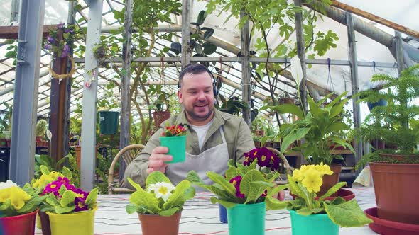 A Young Greenhouse Worker During an Online Video Call  Telling Customers About His Small Business