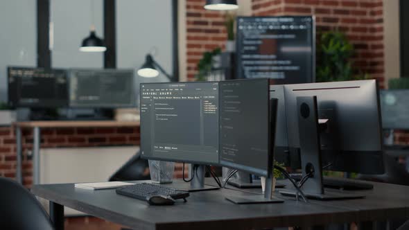 Computer Monitors Displaying Parsing Code in Empty It Agency Office and Computers Compiling Data