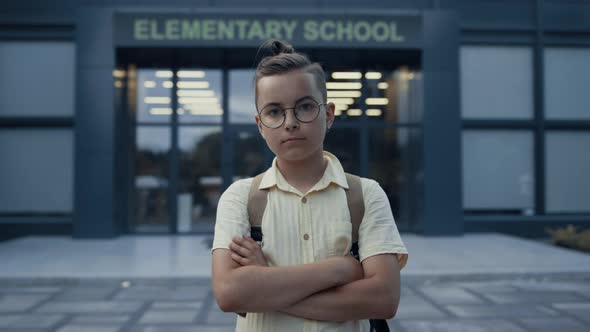 Serious Teen Boy Standing at School Entrance Close Up