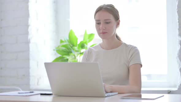 Woman Reacting to Loss While Working in Office