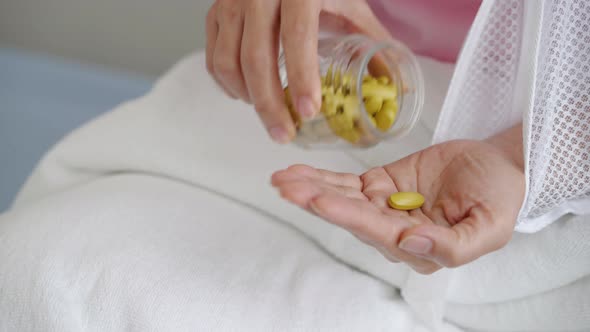 patient's hand pouring medicine on palm, health insurance concept