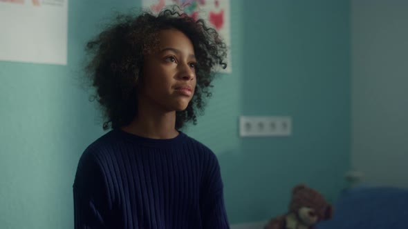 African American Girl Talking with Unknown Doctor Sitting Hospital Close Up