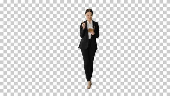 Concentrated woman in a suit writing business, Alpha Channel