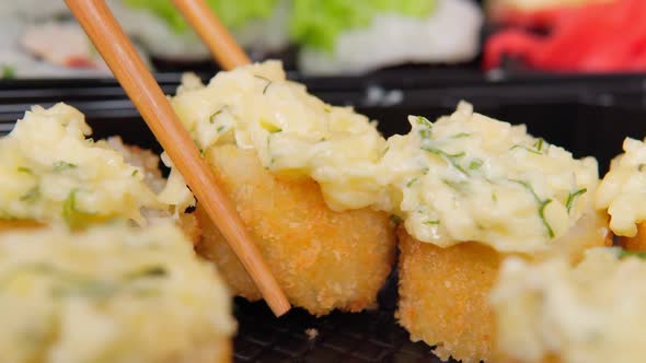 Sushi Rolls are Taken with a Stick Closeup