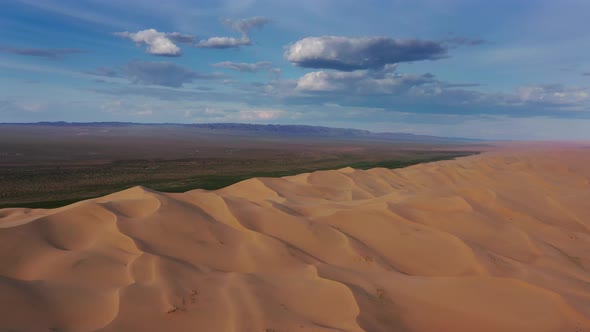 Aerial View of Sand Dunes in Desert at Sunset