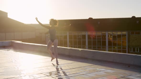 Ballet dancer practicing on rooftop