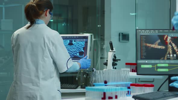 Scientist Nurse Typing Medical Reports on Computer