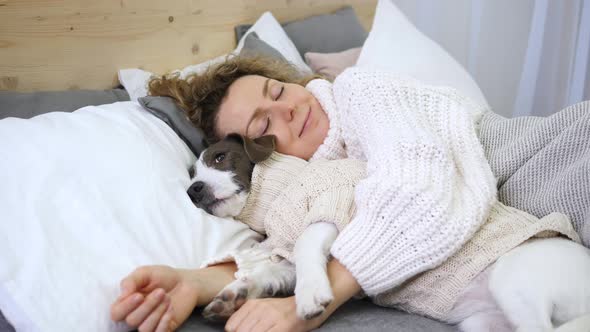 Coziness, Home, Hygge, People And Animals Concept, Woman Sleeping With Dog In Bed