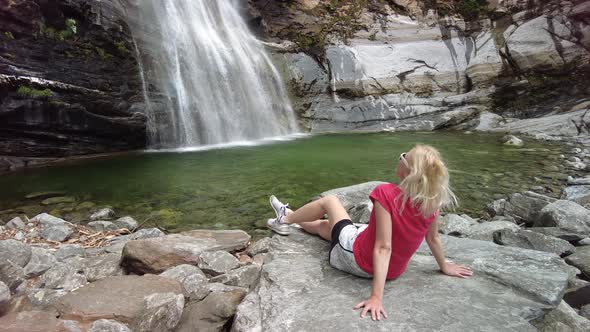Woman in Great Waterfall of Bignasco