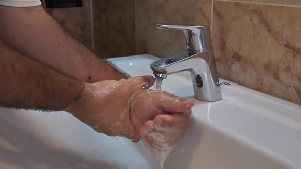 Coronavirus or Covid19 Epidemic Prevention: a Man Wash His Hands in Slow Motion