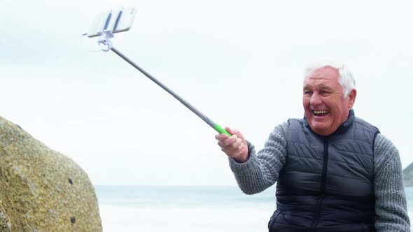 Senior man taking a selfie from selfie stick