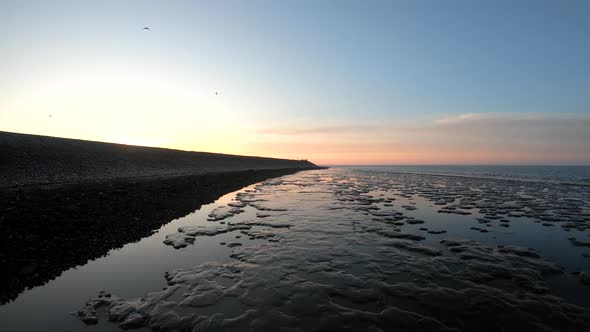 Aerial drone view of the shore at the sunrise