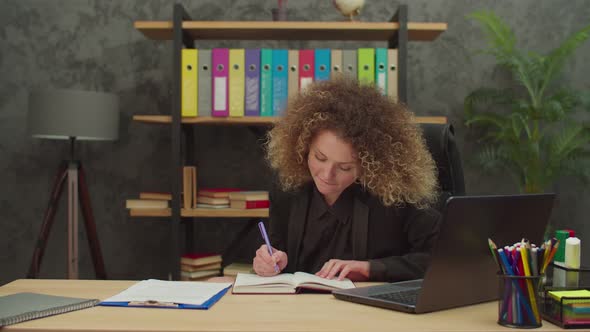 Positive Lovely Businesswoman Relaxing with Legs on Desk at Office