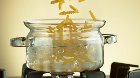 Super Slow Motion Shot of Fresh Fusilli Falling Into Boiling Salted Water at 1000 Fps