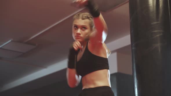 Female Fighter Trains His Punches and Defense in the Boxing Gym Female Trains a Series of Punches