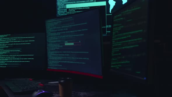 Code On Multiple Computer Screens And Success Downloading Data, Cyber Attack