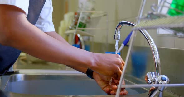 Chef washing hands in sink in kitchen 4k