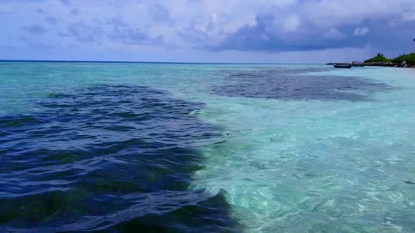 Aerial drone panorama of shore beach time by blue water and sand background