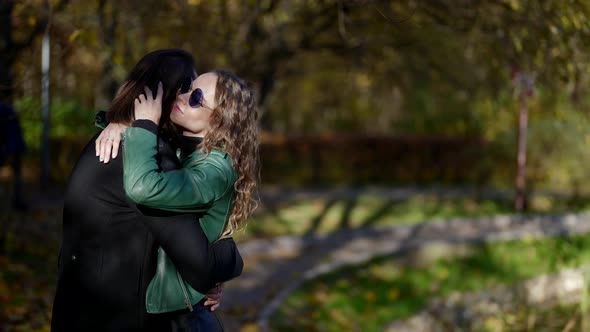 Tender Embrace of Young Woman and Her Beloved Boyfriend in Park in Autumn