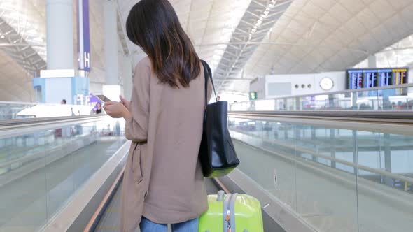 Travel woman use of mobile phone in the airport