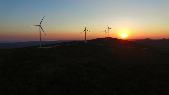 Aerial view of windmills at beautiful colorful sunset