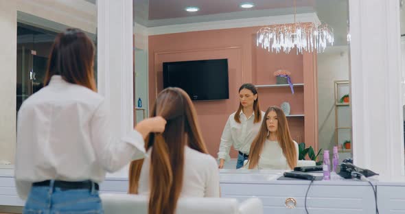 Hairdresser Stylist Prepares Hair for Hairstyle Combing Parting