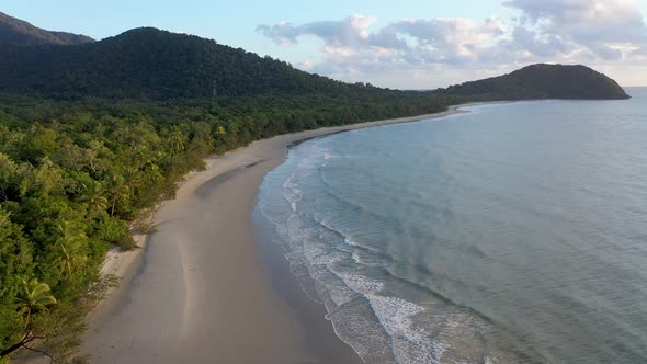 Cape Tribulation backward aerial of palm trees and ocean on overcast day, Daintree Rainforest, Queen