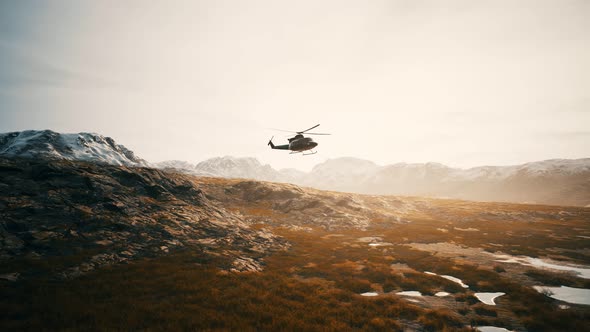Slow Motion Vietnam War Era Helicopter in Mountains alt