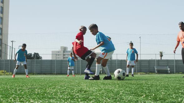 Soccer kids playing in a sunny day