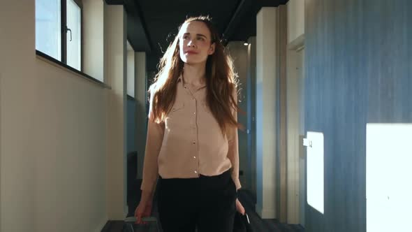 Happy Woman with Travel Suitcase Walking at Hotel Corridor