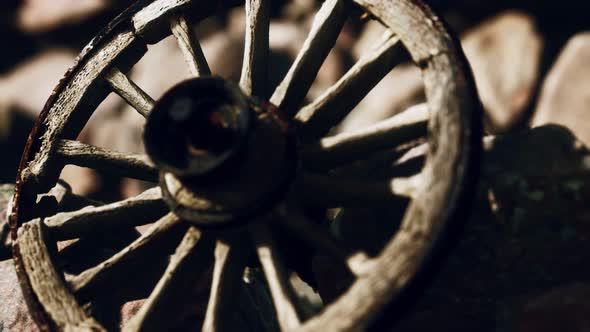 Old Wooden Wheel on Rocks