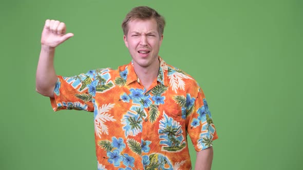 Young Sad Tourist Man Giving Thumbs Down