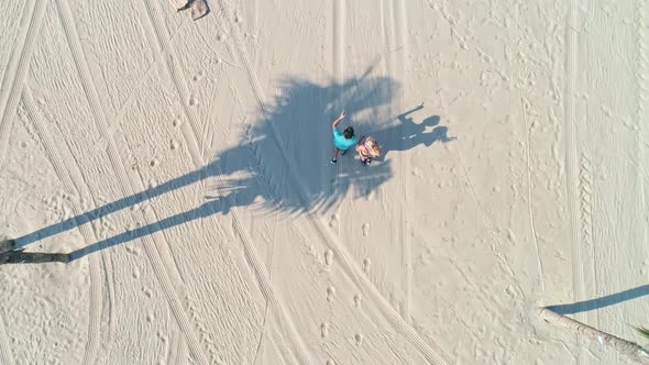 Drone point of couple jogging on the tropical beach, Shot with RED helium camera