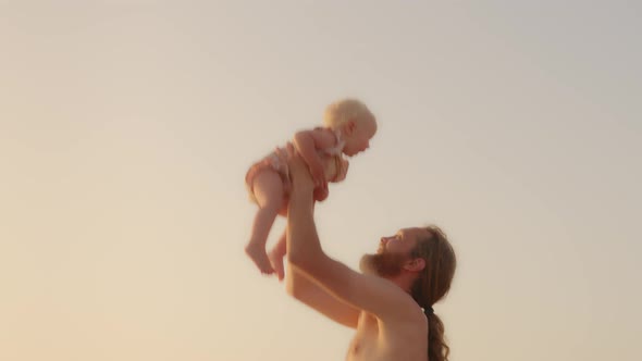 Adult Caucasian Bearded Father Playing with Son Daughter Infant Child Outdoors Happy Family Kid