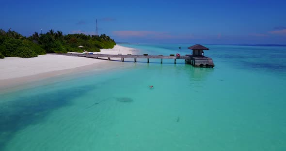 Wide overhead copy space shot of a white sand paradise beach and aqua blue ocean background in high 