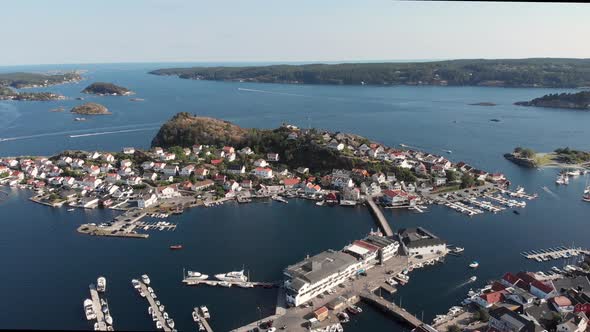 Aerial pan showing idyllic Kragero coastal town's marina, Southern Norway