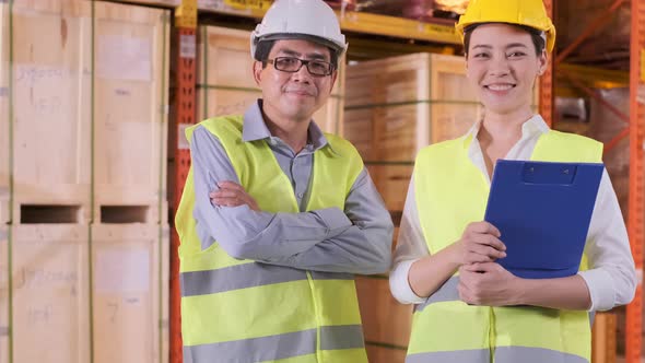 asian Male and Female Industrial Engineers in Hard Hats