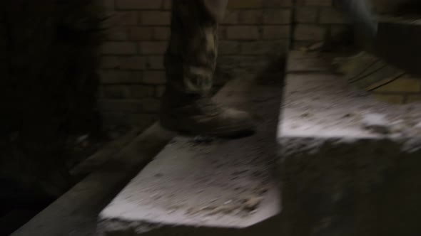 Soldiers Legs in Army Boots Climbing Up Staircase